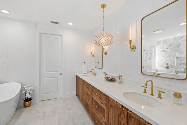 bathroom featuring tile patterned flooring, vanity, and shower with separate bathtub