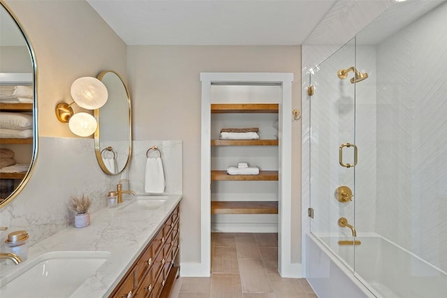 bathroom featuring vanity and combined bath / shower with glass door