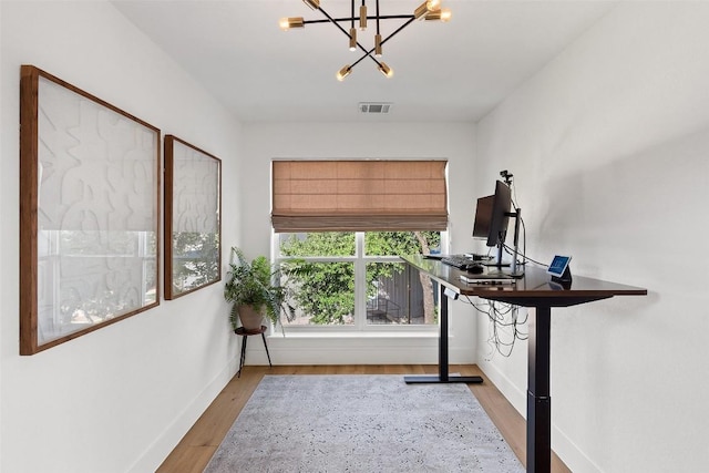 interior space featuring a notable chandelier and light wood-type flooring