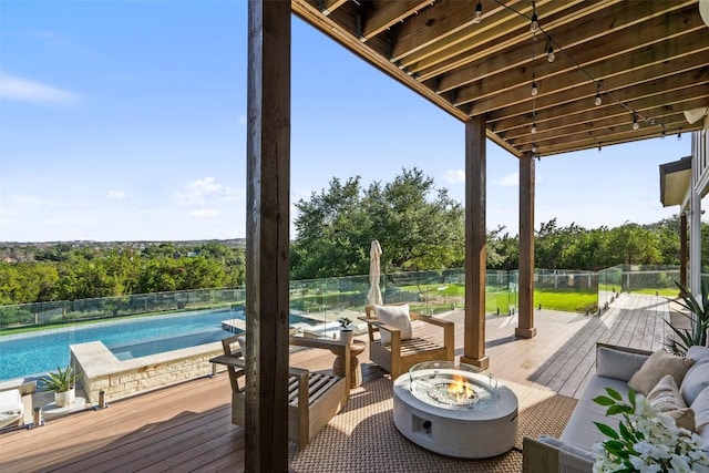 deck with a fenced in pool and an outdoor living space with a fire pit