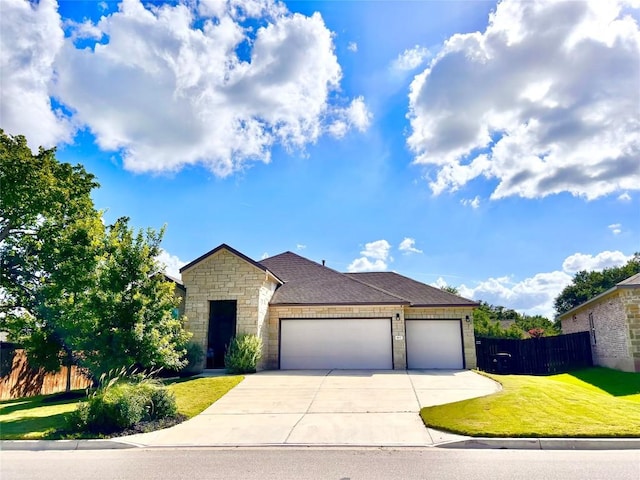 view of front of property with a garage and a front yard