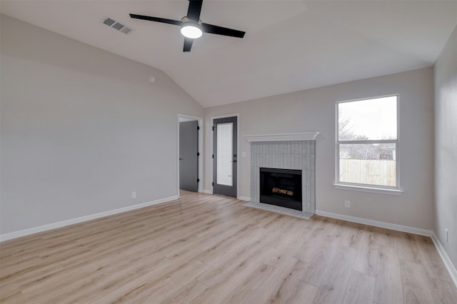 unfurnished living room with ceiling fan, light hardwood / wood-style floors, a fireplace, and vaulted ceiling