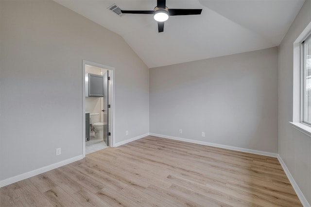 unfurnished bedroom featuring connected bathroom, ceiling fan, lofted ceiling, and light wood-type flooring