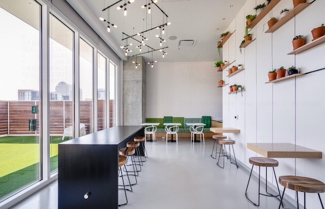 dining area with concrete flooring and a chandelier