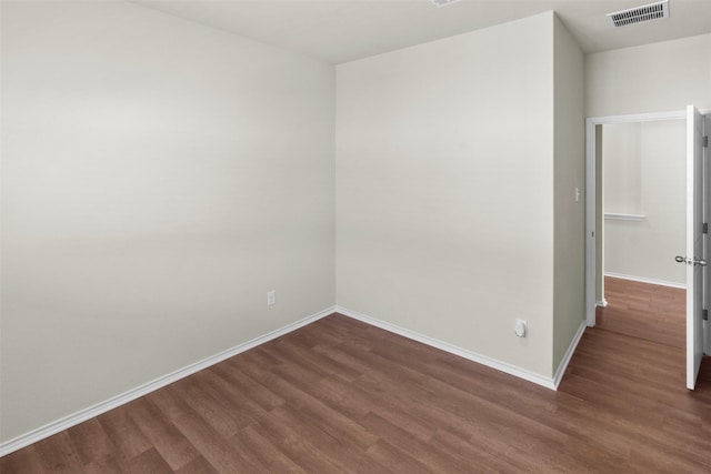 spare room featuring dark hardwood / wood-style floors