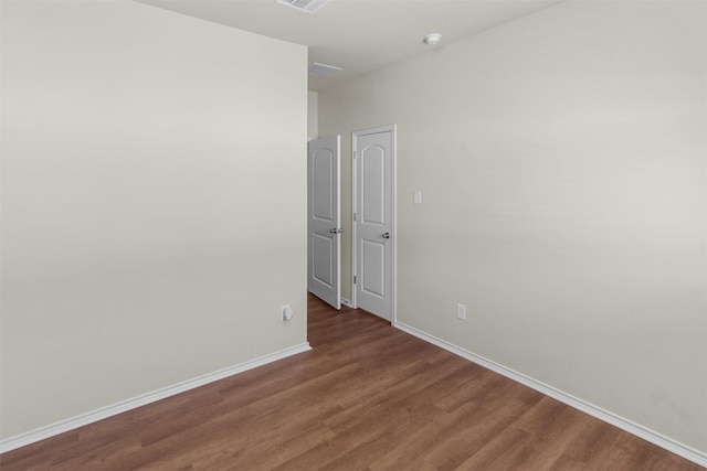 empty room featuring dark wood-type flooring