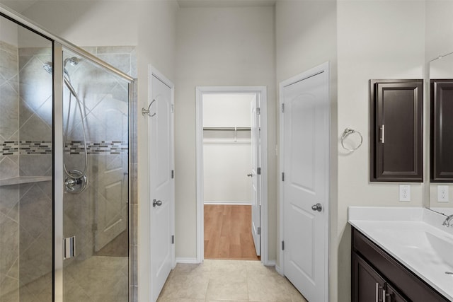 bathroom featuring tile patterned floors, vanity, and an enclosed shower