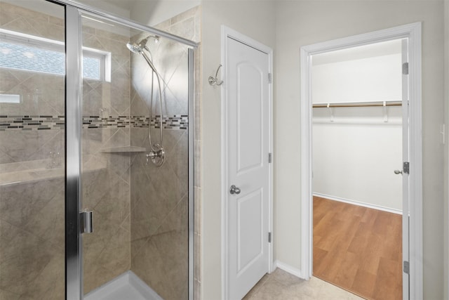 bathroom featuring wood-type flooring and walk in shower