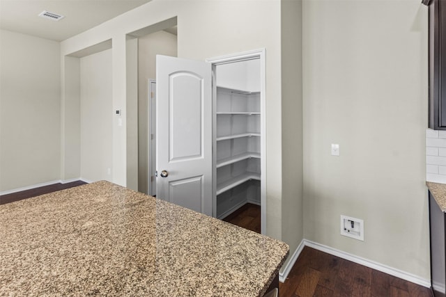 unfurnished bedroom featuring dark wood-type flooring