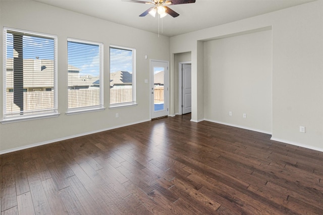 spare room featuring plenty of natural light and dark wood-type flooring