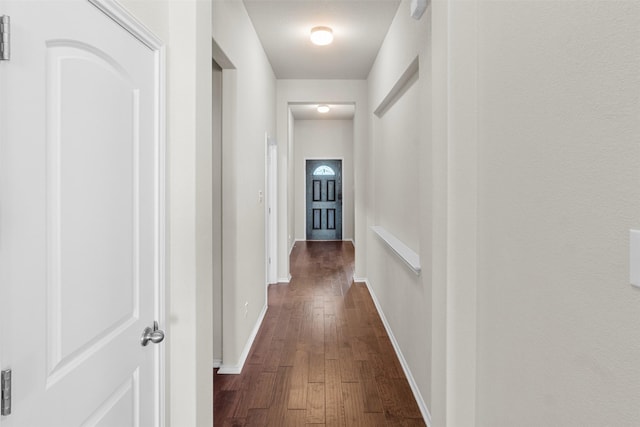 corridor with dark hardwood / wood-style floors