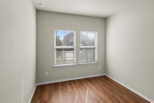 spare room featuring dark hardwood / wood-style flooring