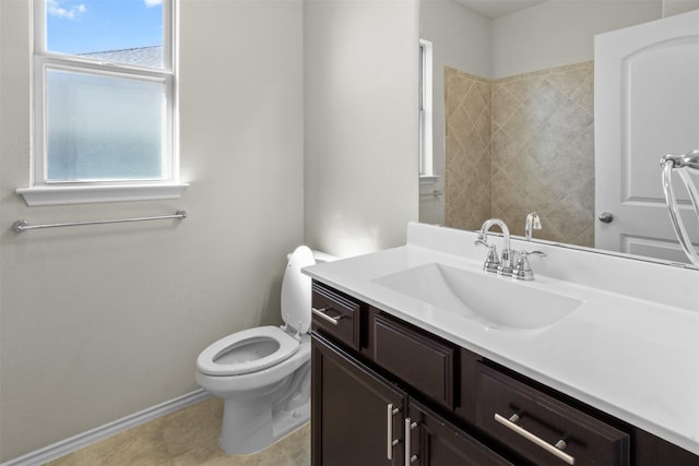 bathroom with tile patterned flooring, vanity, and toilet