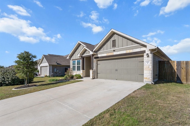 view of front of home with a front yard and a garage