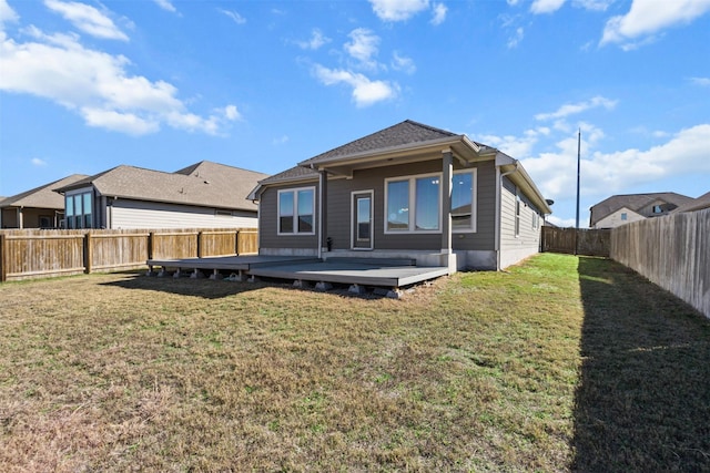 back of house with a yard and a deck