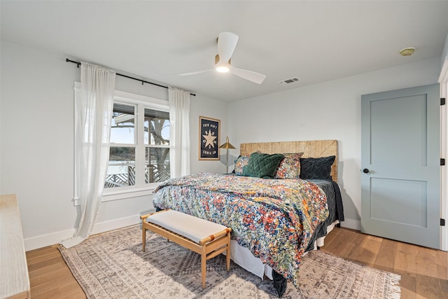 bedroom featuring ceiling fan and light hardwood / wood-style flooring