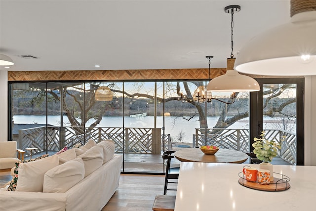 interior space with a water view and a notable chandelier