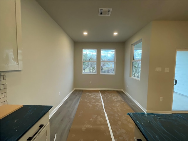 unfurnished dining area featuring dark wood-type flooring