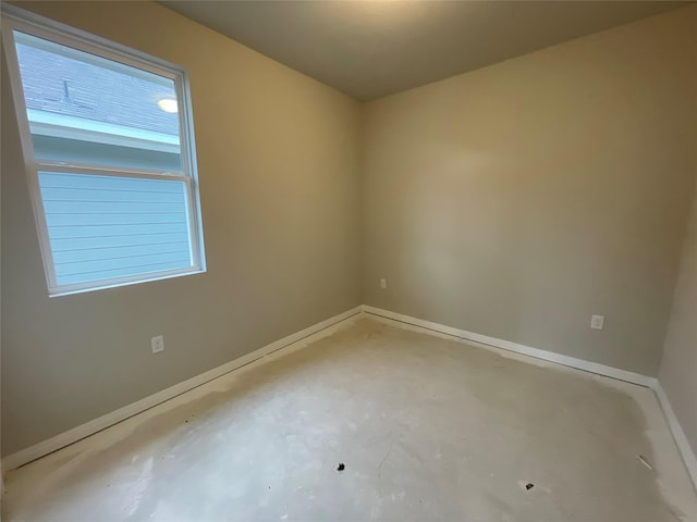 empty room featuring concrete floors and plenty of natural light