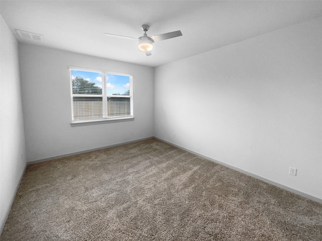 carpeted spare room with ceiling fan