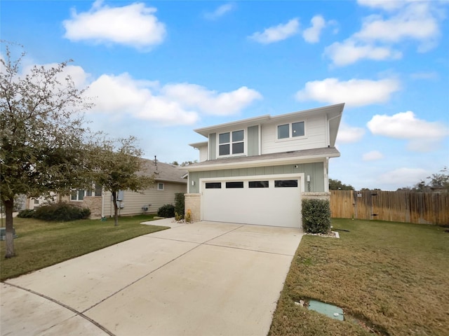 view of front of property featuring a front yard and a garage