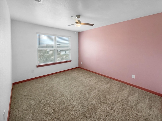 carpeted empty room featuring ceiling fan