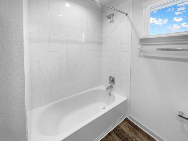 bathroom featuring wood-type flooring and shower / bath combination