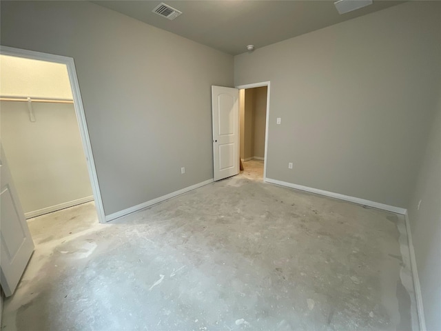 unfurnished bedroom featuring a closet and a walk in closet