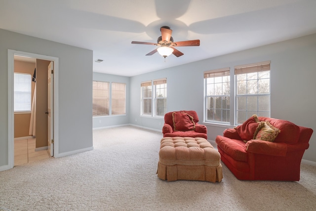 sitting room featuring carpet and ceiling fan