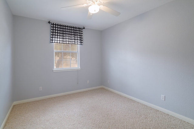 spare room featuring ceiling fan and carpet floors