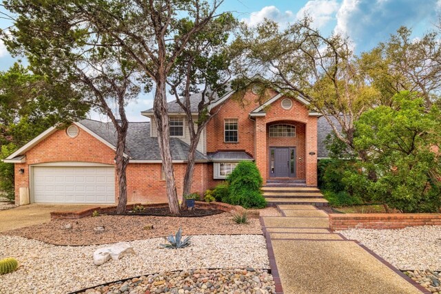 857 Mission Hills Dr, New Braunfels, TX 78130 - traditional-style house with brick siding, an attached garage, driveway, and a shingled roof