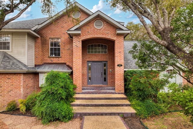 857 Mission Hills Dr, New Braunfels, TX 78130 - view of exterior entry with brick siding and roof with shingles