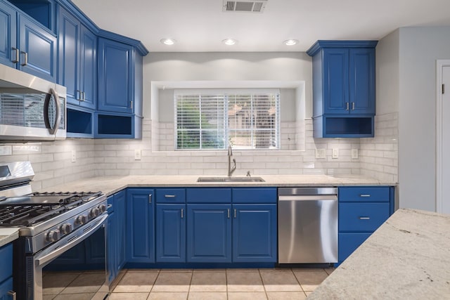 kitchen with sink, blue cabinets, and appliances with stainless steel finishes