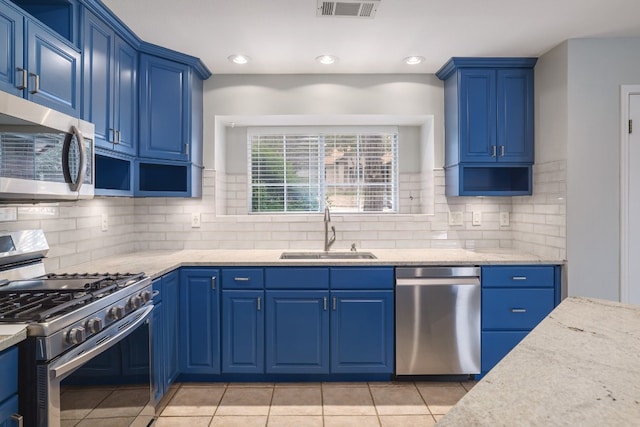 857 Mission Hills Dr, New Braunfels, TX 78130 - kitchen featuring appliances with stainless steel finishes, decorative backsplash, light stone countertops, light tile patterned floors, and recessed lighting