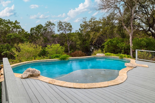 view of swimming pool with a wooden deck