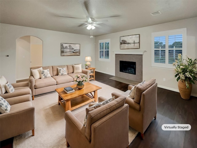 living room with ceiling fan and dark hardwood / wood-style flooring