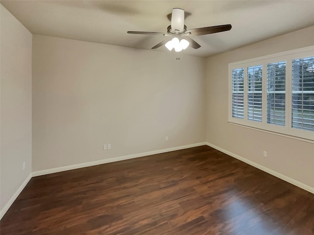 empty room featuring dark hardwood / wood-style floors and ceiling fan