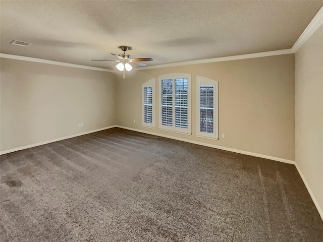 empty room featuring dark colored carpet, ceiling fan, ornamental molding, and a textured ceiling