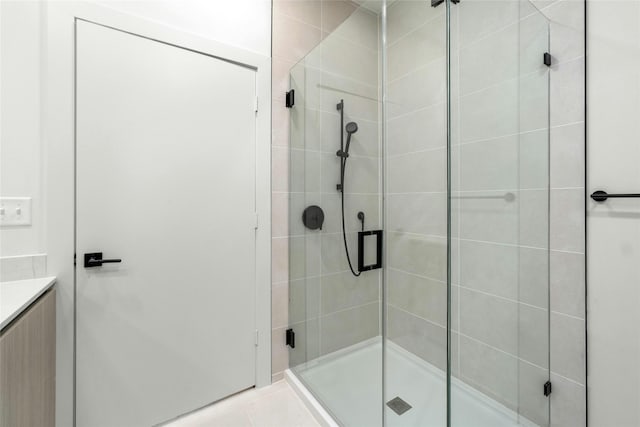 full bath featuring tile patterned flooring and a stall shower