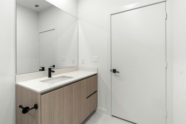 bathroom with tile patterned floors, visible vents, and vanity