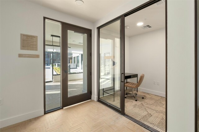 entryway with baseboards and visible vents