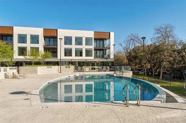 view of swimming pool with fence