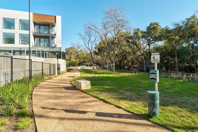 view of home's community featuring fence