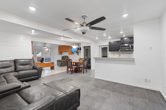 tiled living room with ceiling fan