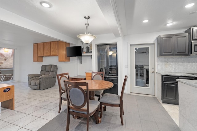 dining space featuring beam ceiling