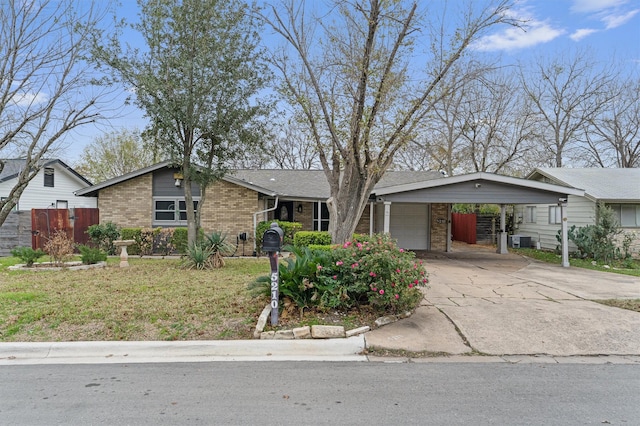 ranch-style home with a front yard, a garage, and a carport