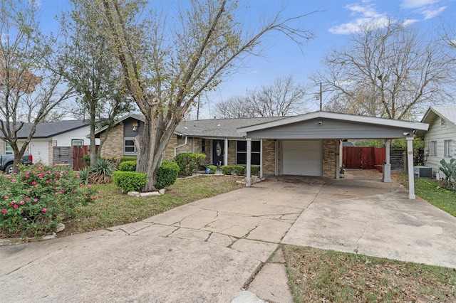 ranch-style house with a garage, a carport, and central air condition unit