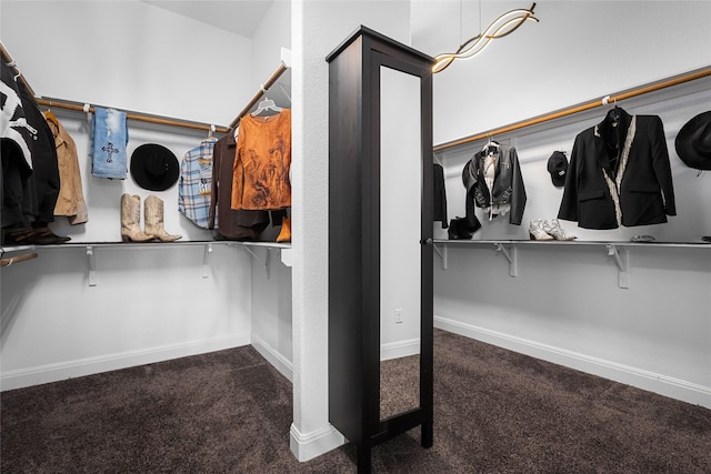 spacious closet featuring dark carpet