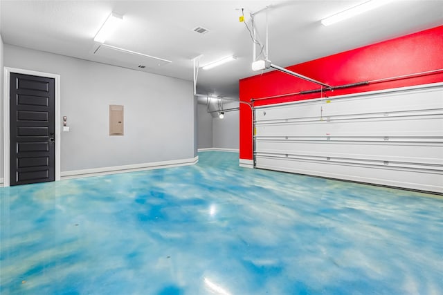 garage featuring electric panel and a garage door opener