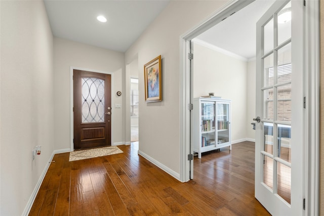 foyer with wood-type flooring and ornamental molding